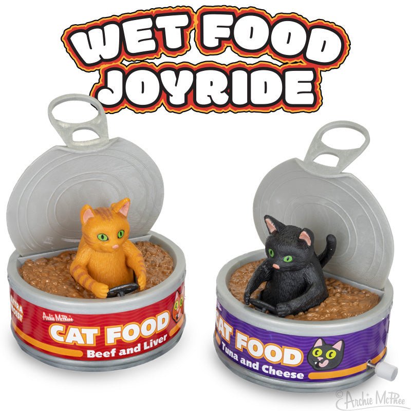 Humorous feline toys operate can-shaped vehicles labeled Cat Food, with the text "Wet Food Joyride" above, incorporating soft vinyl components for a fun-filled experience.