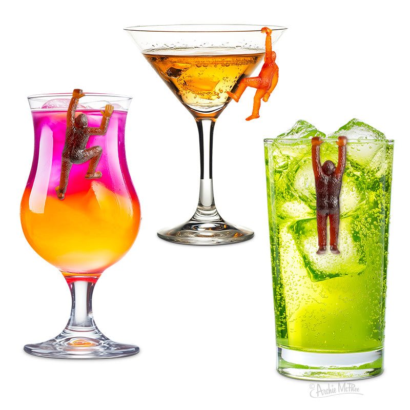 Three vibrant cocktails with Bigfoot Drink Markers hanging on the rims add a quirky Pacific Northwest party vibe.