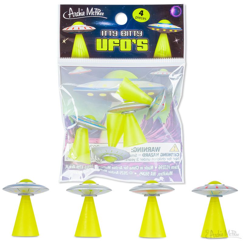 Four small soft vinyl UFO toys with yellow beams, called Itty Bitty UFO's by Archie McPhee.