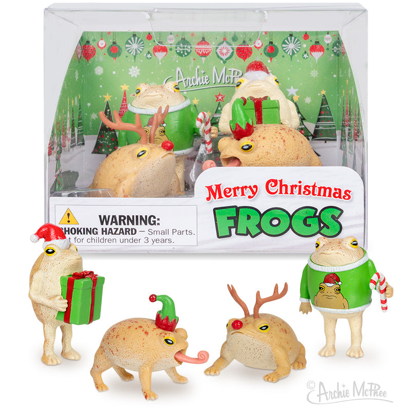 Celebrate the season with Merry Christmas Frogs—a set of four collectible vinyl frog figures in festive outfits, displayed in front of packaging that reads Merry Christmas Frogs. The perfect holiday collectible!.